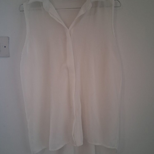 Sleeveless white shirt top