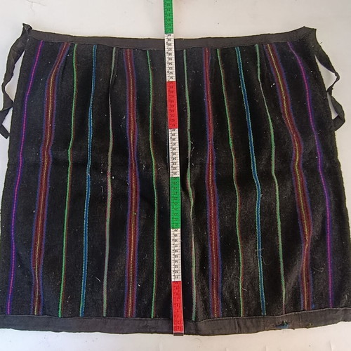 Traditional apron with colorful vertical stripes, used