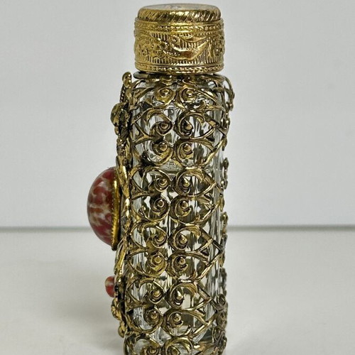 Vintage perfume flacon with filigree metalwork and red cabochon