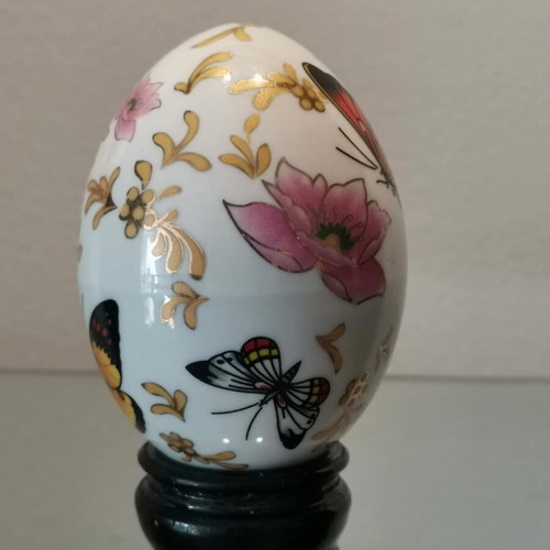 Porcelain egg used with butterflies and wooden base