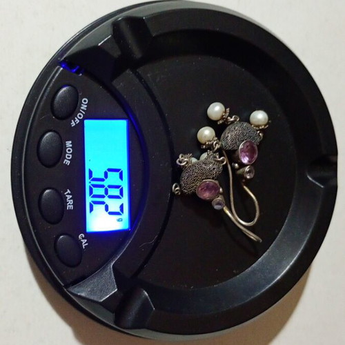 Silver earrings used with purple stones and pearls