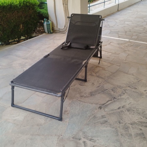 Black sunbed with moveable umbrella and comfort pillow like new