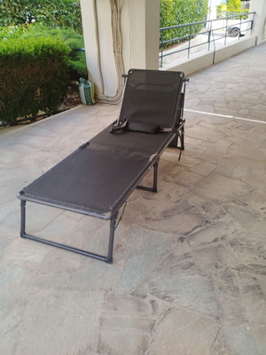 Black sunbed with moveable umbrella and comfort pillow like new
