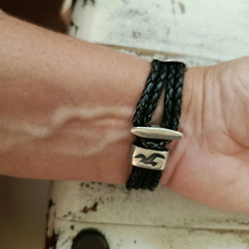 Black leather-type bracelet with silver elements used