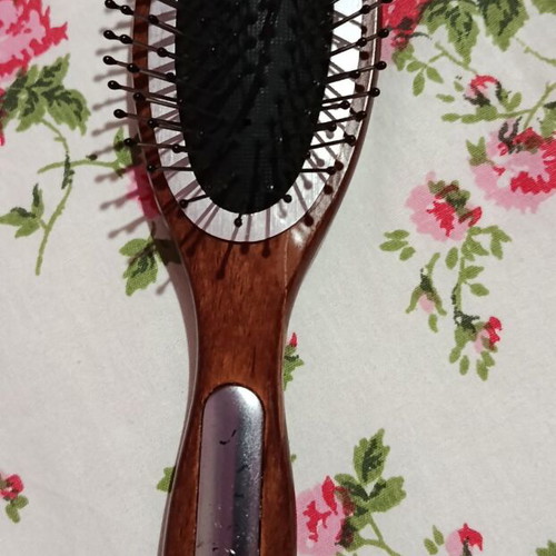Small hairbrush with metal pins and rubber cushion