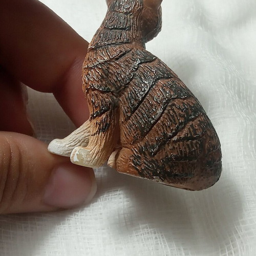 Cat miniature with realistic brown and white fur