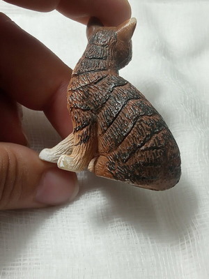 Cat miniature with realistic brown and white fur