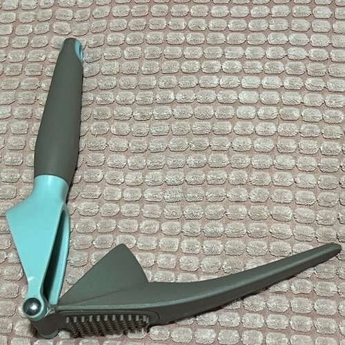 Garlic press used with ergonomic handle and easy cleaning