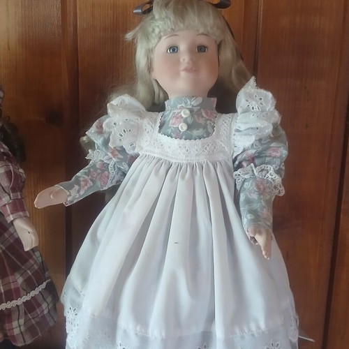 Porcelain doll like new with vintage lace dress and floral details