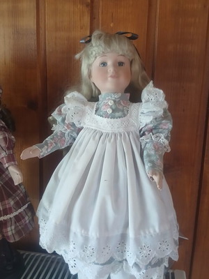 Porcelain doll like new with vintage lace dress and floral details