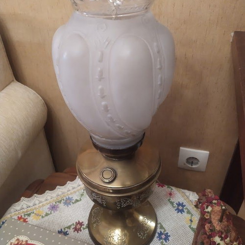 Vintage table lamp in old oil lamp style with glass, used
