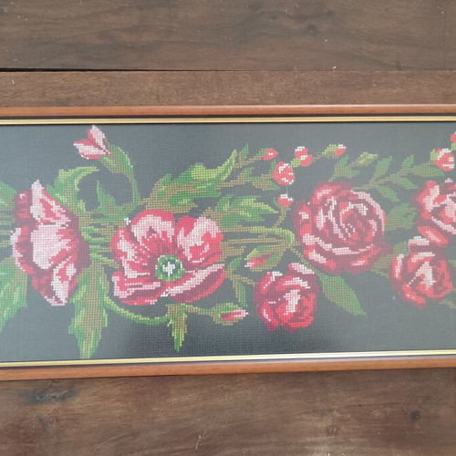 Vintage cross stitch picture of roses and poppies