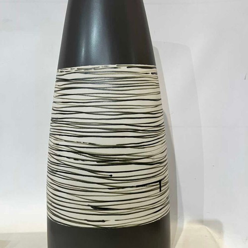 Modern ceramic conical vase with black and white striped design used