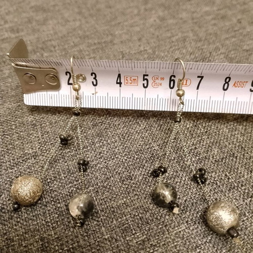 Dangling earrings used with black and gray beads