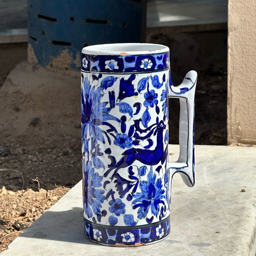 Vintage handmade ceramic cup and decorative Delft style jug used, blue floral