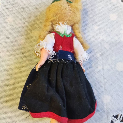 Retro doll used with traditional costume and broken leg