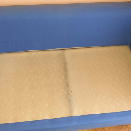 Two-seater sofa used without two back cushions