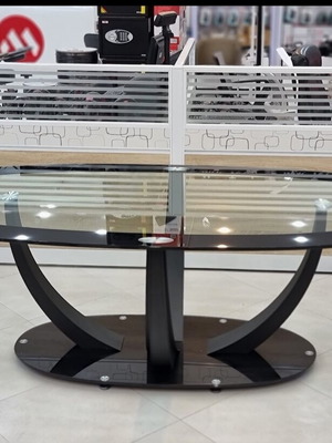 Glass table modern with oval surface and metal base