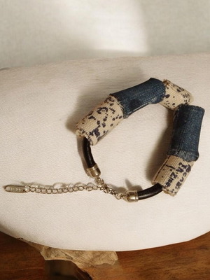 Handmade leather cord bracelet with blue and white beads, silver clasp