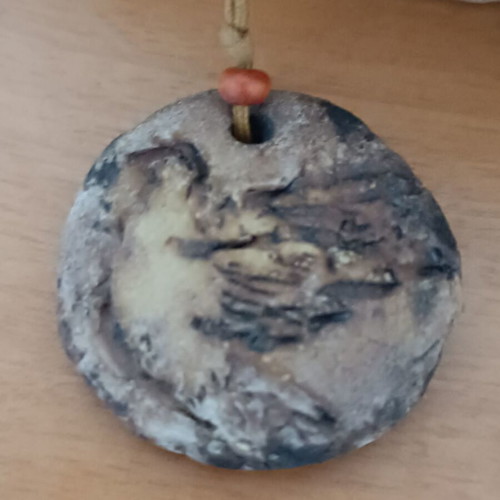 Ceramic handmade necklace like new with embossed dove and cord