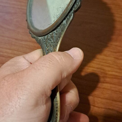 Brass hand mirror used with embossed peacock decoration