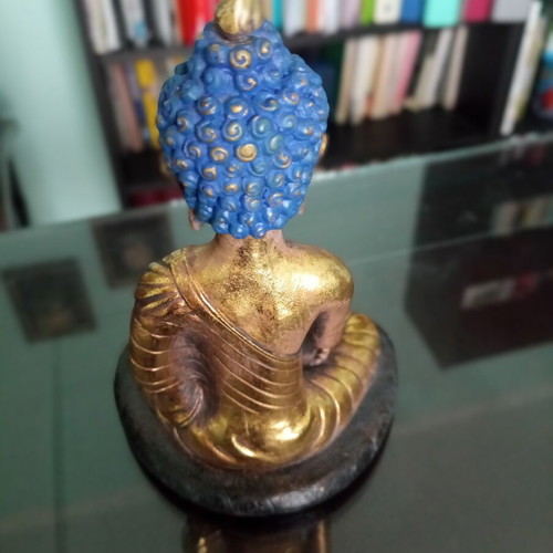 Golden ceramic Buddha statue sitting meditation decoration