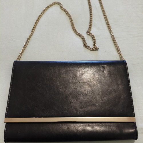 Black clutch bag with gold chain used, synthetic leather