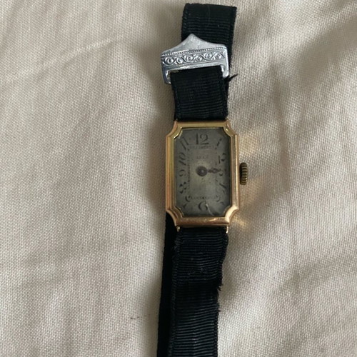 Vintage women's wristwatch used with 14K gold and black strap