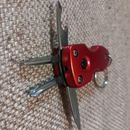 Mini multitool keychain KTEO used with flashlight