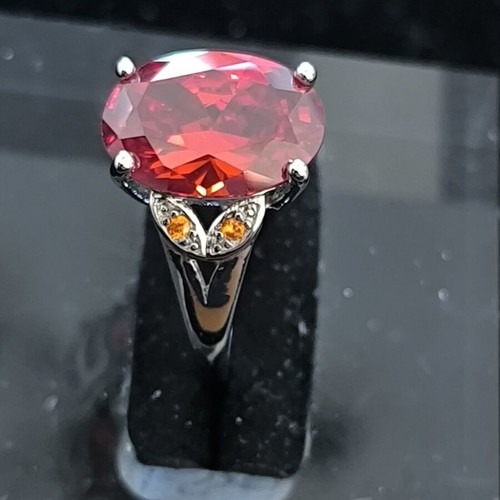 Ring with Large Red Ruby-Colored Stone and Decorative Stones
