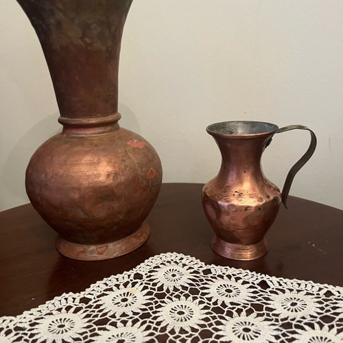 Two decorative hammered copper vases used with natural patina
