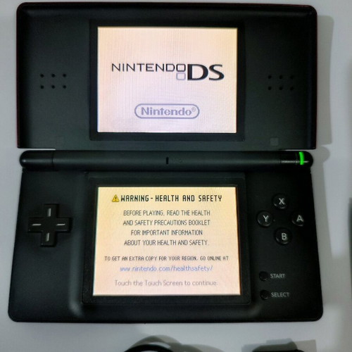 Nintendo DS Lite console used with Pokemon LeafGreen cartridge and accessories