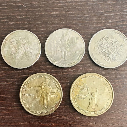 Sports-themed coins used, two 100 and three 500 drachmas