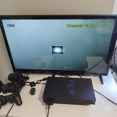 PlayStation 2 Fat console used with 2 controllers, memory card and 21 games