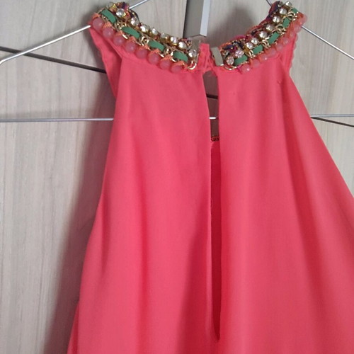 Coral dress with a jewel tie at the neck