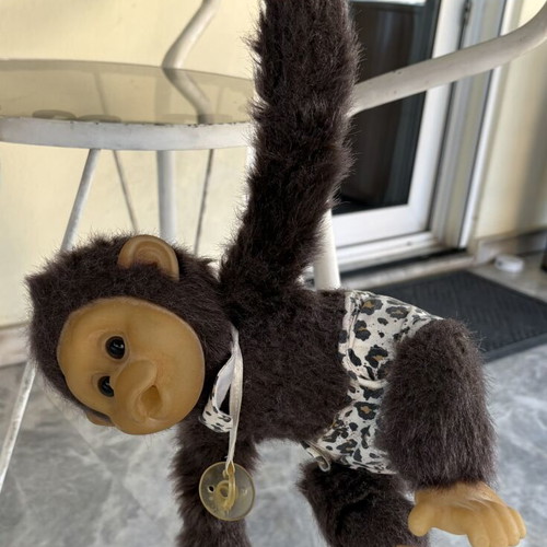 Vintage plush monkey toy with sound and hanging feature