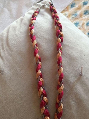 Statement necklace with braided cord and decorative tassel like new