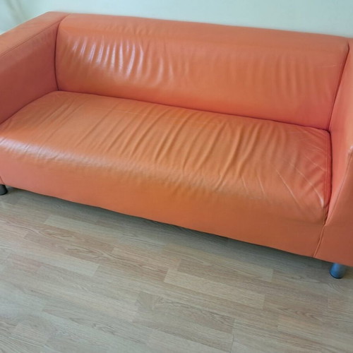 Orange two-seater sofa leather used with minor damages