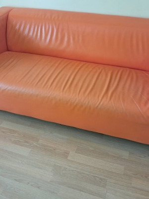 Orange two-seater sofa leather used with minor damages