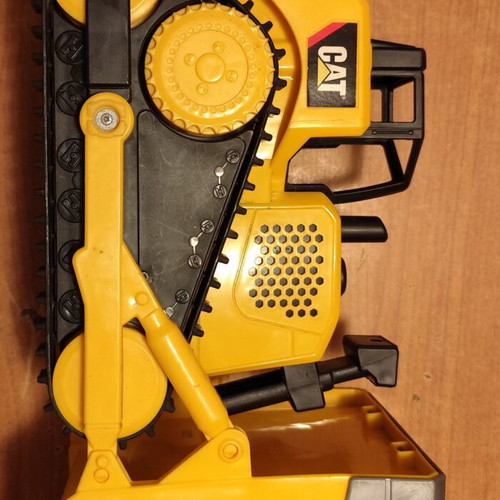 CAT bulldozer toy used with moving tracks and gradual forward-back motion