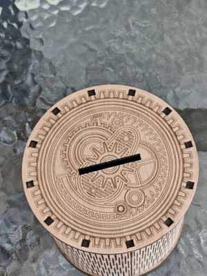 Handmade wooden laser-cut piggy bank with mechanical design
