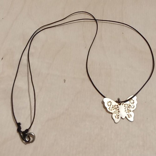 Butterfly pendant used, metallic gold with synthetic silk cord