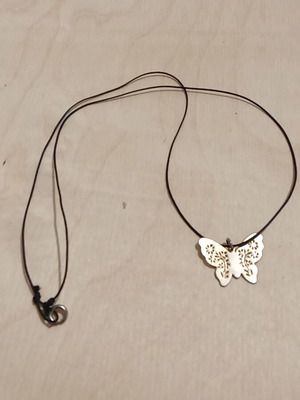 Butterfly pendant used, metallic gold with synthetic silk cord