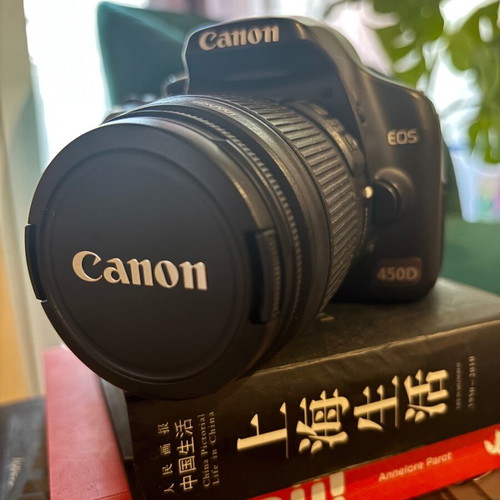 Canon EOS 450D camera used with charger and straps