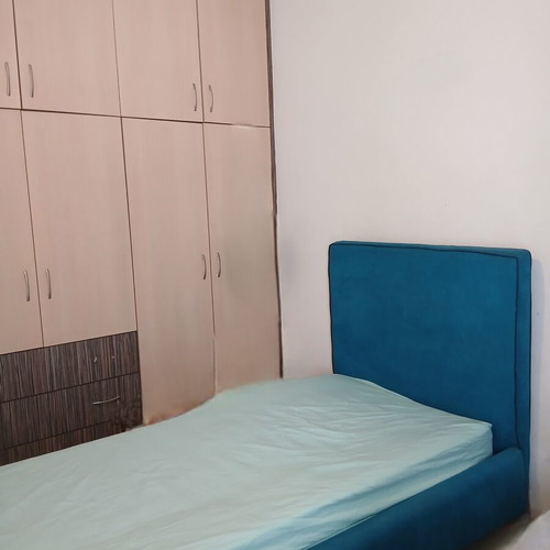 Single bed with teal fabric headboard and mattress, like new