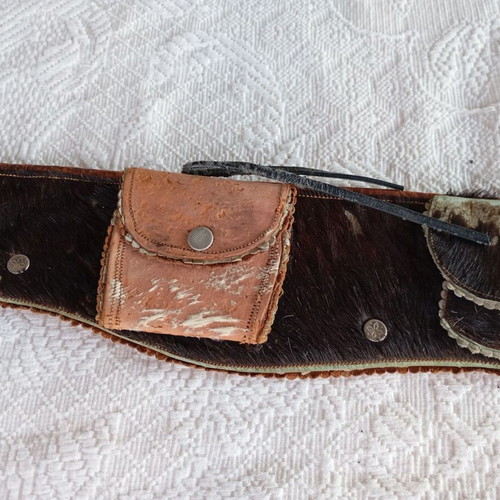 Vintage leather belt with cartridge and pistol holster used