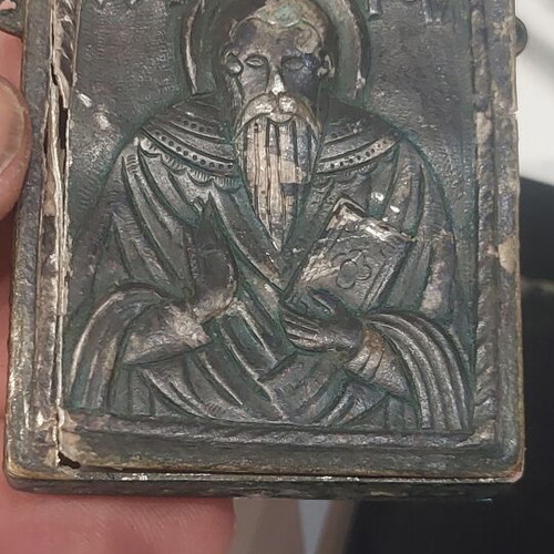 Old religious amulet with wear, needs repair