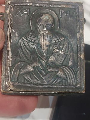 Old religious amulet with wear, needs repair