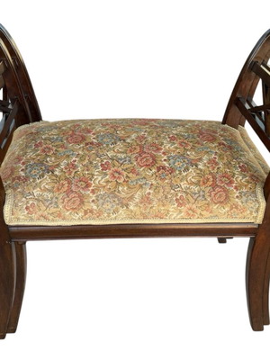 Wooden stool with carved high arms