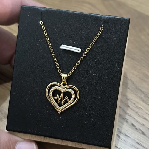 Gold-tone heart necklace with pulse design and sparkling stones